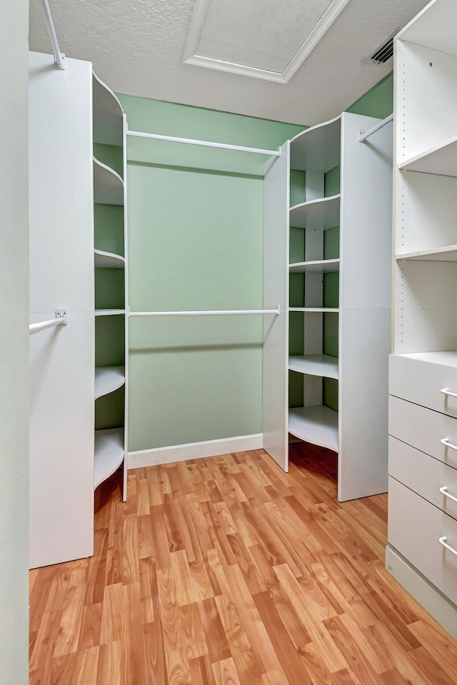 spacious closet with light hardwood / wood-style floors