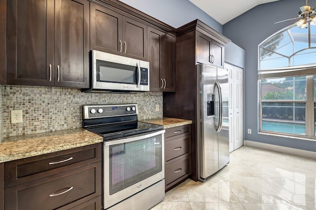 kitchen featuring ceiling fan, tasteful backsplash, light stone counters, dark brown cabinets, and appliances with stainless steel finishes