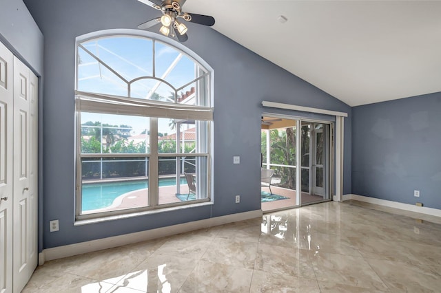 unfurnished living room featuring ceiling fan and vaulted ceiling