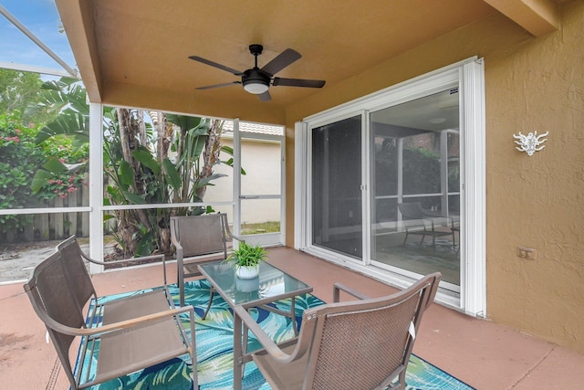 view of patio / terrace with ceiling fan and a lanai