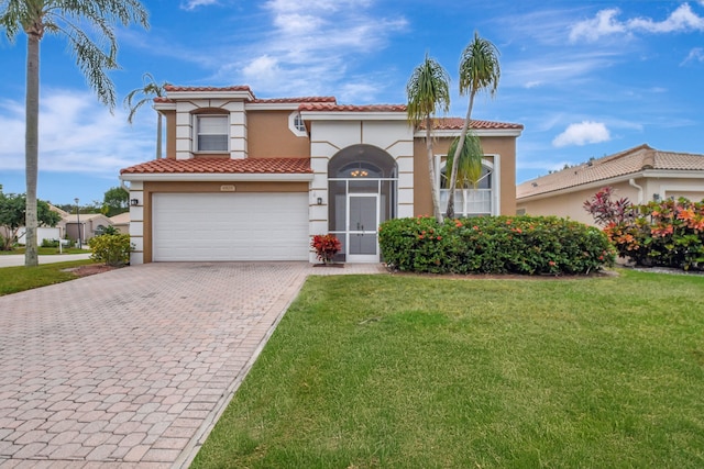 mediterranean / spanish home with a front yard and a garage