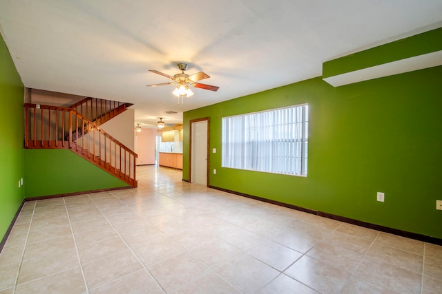 unfurnished room with ceiling fan and light tile patterned flooring