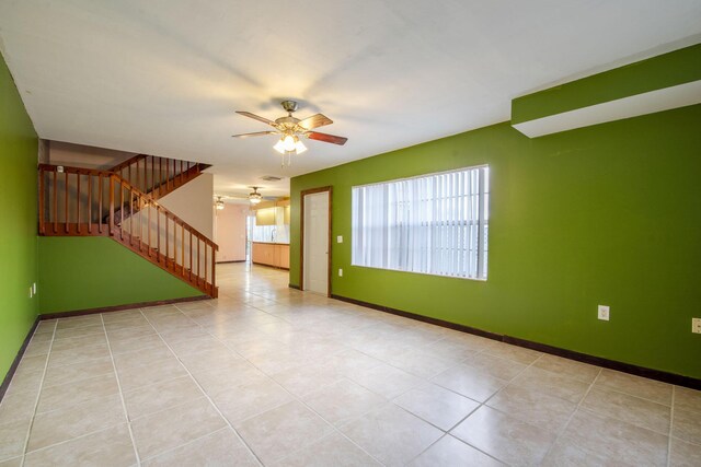 3537 SW Sunset Trace Cir, Palm City, FL 34990 - unfurnished living room with ceiling fan, stairs, baseboards, and tile patterned floors