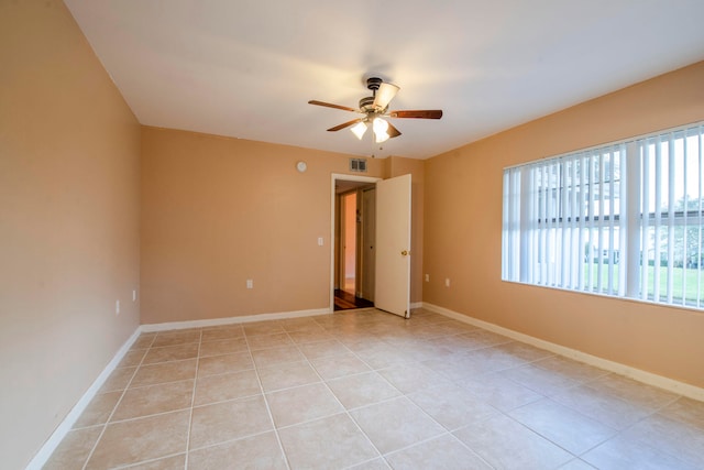 empty room with light tile patterned floors and ceiling fan