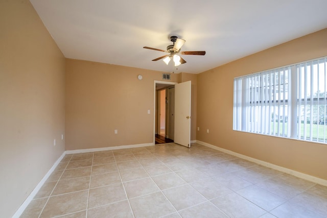 3537 SW Sunset Trace Cir, Palm City, FL 34990 - spare room featuring ceiling fan, plenty of natural light, light tile patterned floors, and baseboards