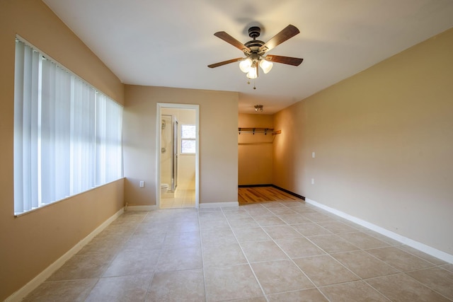3537 SW Sunset Trace Cir, Palm City, FL 34990 - empty room featuring a ceiling fan, light tile patterned floors, and baseboards