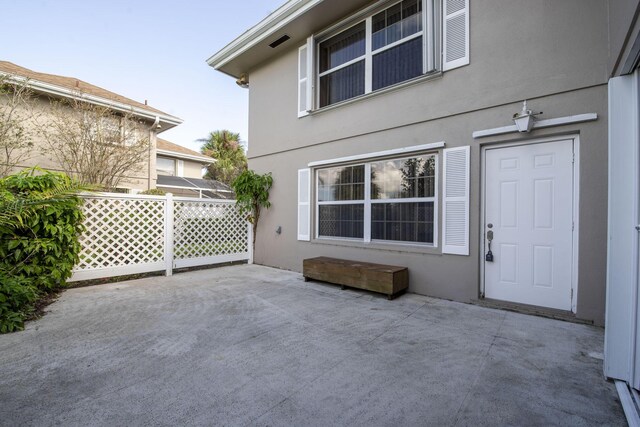 3537 SW Sunset Trace Cir, Palm City, FL 34990 - view of exterior entry featuring a patio and stucco siding