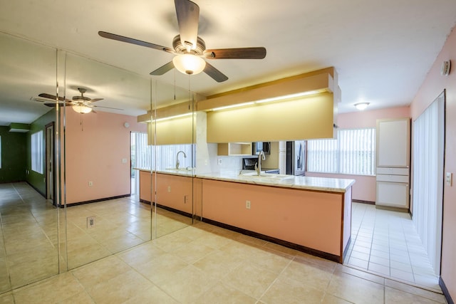 3537 SW Sunset Trace Cir, Palm City, FL 34990 - kitchen featuring stainless steel fridge, ceiling fan, a sink, and light stone counters