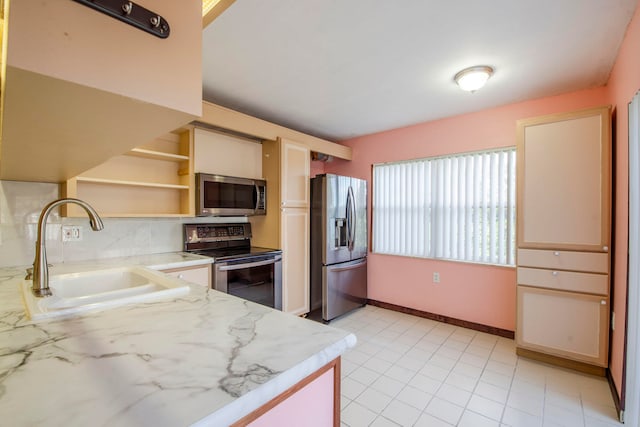 kitchen with light tile patterned floors, stainless steel appliances, tasteful backsplash, and sink