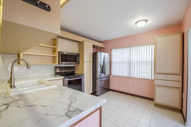 3537 SW Sunset Trace Cir, Palm City, FL 34990 - kitchen with appliances with stainless steel finishes, a sink, open shelves, baseboards, and cream cabinets