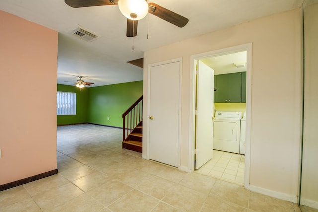 3537 SW Sunset Trace Cir, Palm City, FL 34990 - spare room with a ceiling fan, independent washer and dryer, light tile patterned floors, stairs, and baseboards