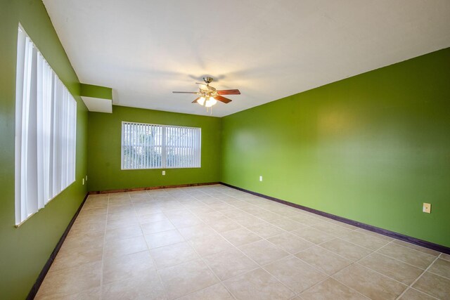 3537 SW Sunset Trace Cir, Palm City, FL 34990 - empty room with a ceiling fan, baseboards, and light tile patterned floors