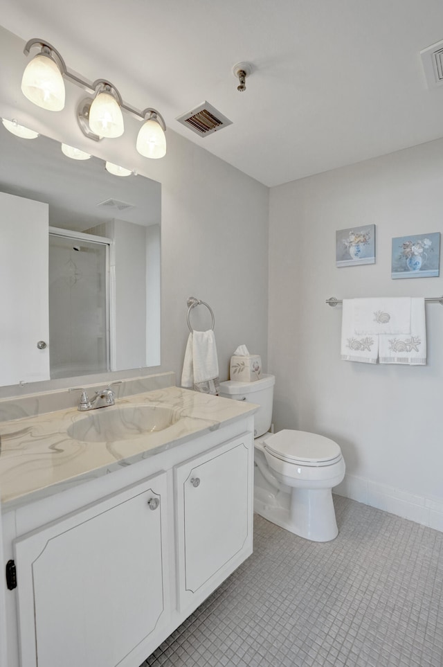 bathroom with tile patterned floors, vanity, toilet, and a shower with shower door