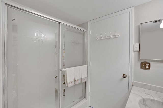 bathroom with a shower with shower door