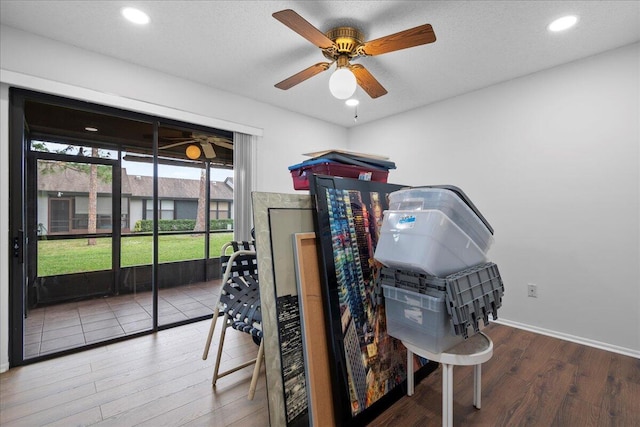 interior space featuring hardwood / wood-style floors, ceiling fan, and a textured ceiling