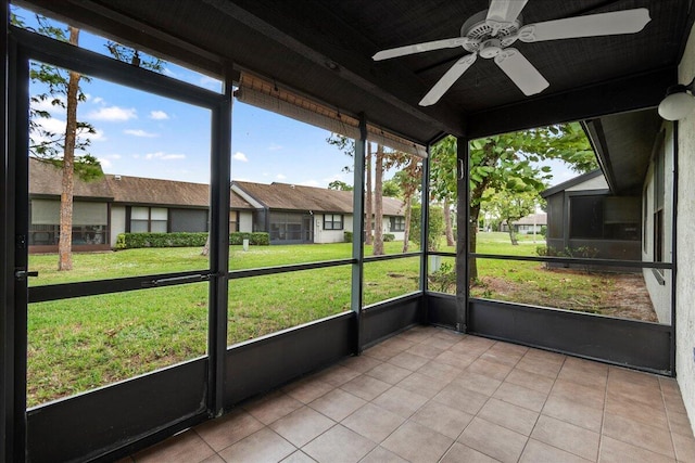 unfurnished sunroom featuring ceiling fan