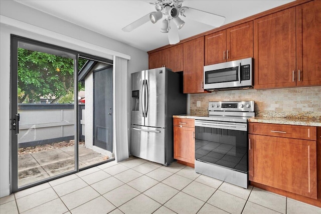 kitchen with decorative backsplash, ceiling fan, light tile patterned floors, and stainless steel appliances