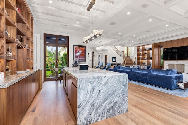 kitchen featuring a center island, coffered ceiling, french doors, light hardwood / wood-style flooring, and beam ceiling