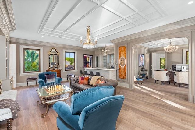 living room with a chandelier, light hardwood / wood-style floors, crown molding, and coffered ceiling