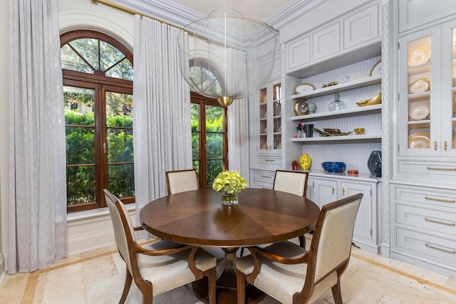 dining area featuring ornamental molding and french doors