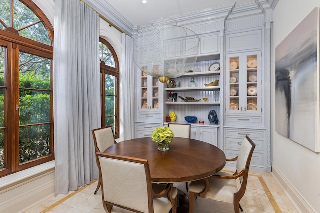 dining room with a wealth of natural light and ornamental molding