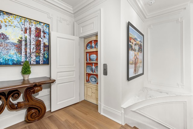 hall featuring ornamental molding and light wood-type flooring