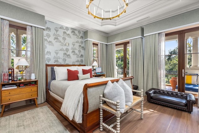 bedroom featuring wood-type flooring, multiple windows, and ornamental molding