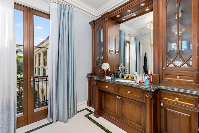 bathroom with vanity and ornamental molding