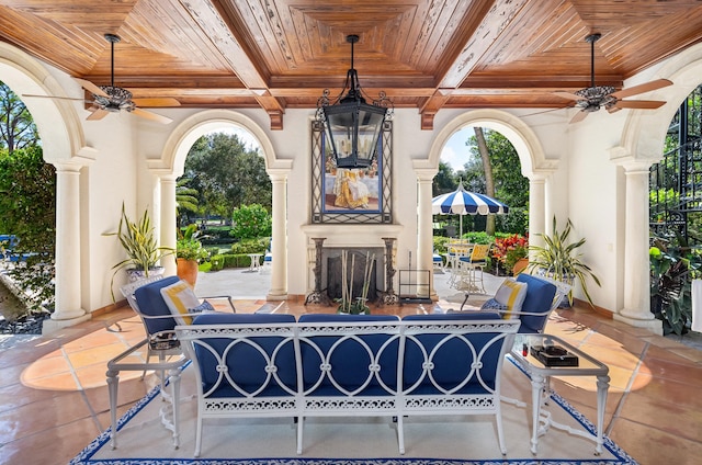 view of patio with ceiling fan and an outdoor fireplace