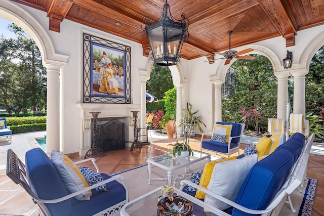 view of patio / terrace featuring an outdoor living space with a fireplace and ceiling fan