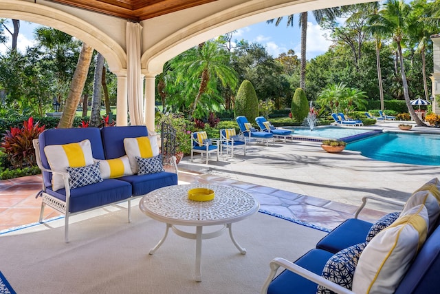 view of patio featuring pool water feature and outdoor lounge area