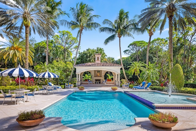 view of pool with a gazebo, a patio area, and an outdoor fireplace