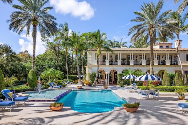 view of swimming pool with a patio and pool water feature