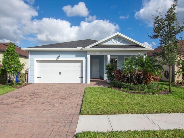 single story home with a garage and a front lawn