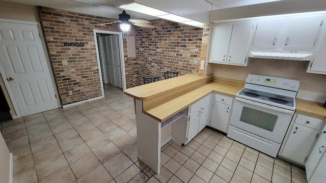 kitchen featuring exhaust hood, white cabinetry, and electric stove