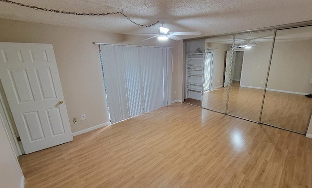 unfurnished bedroom with ceiling fan, light hardwood / wood-style floors, and a textured ceiling