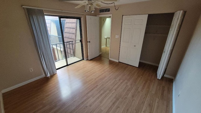 unfurnished bedroom featuring ceiling fan, a closet, access to exterior, and light hardwood / wood-style flooring