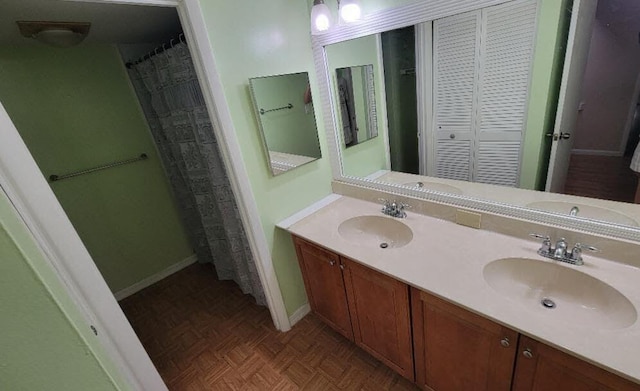 bathroom with vanity and parquet flooring