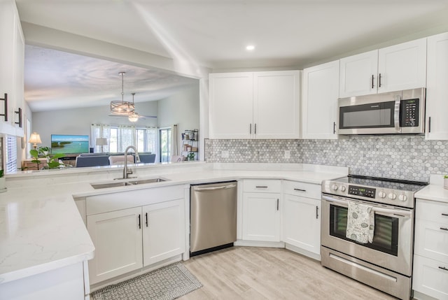 kitchen with tasteful backsplash, white cabinetry, sink, and appliances with stainless steel finishes