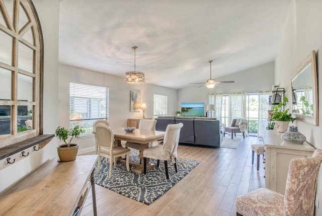 dining area featuring light hardwood / wood-style floors, vaulted ceiling, and ceiling fan