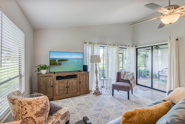 living room featuring light wood-type flooring, ceiling fan, and lofted ceiling