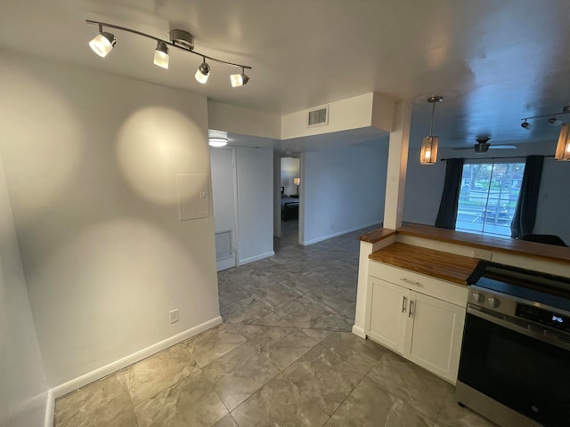 kitchen with pendant lighting, wall oven, and white cabinetry