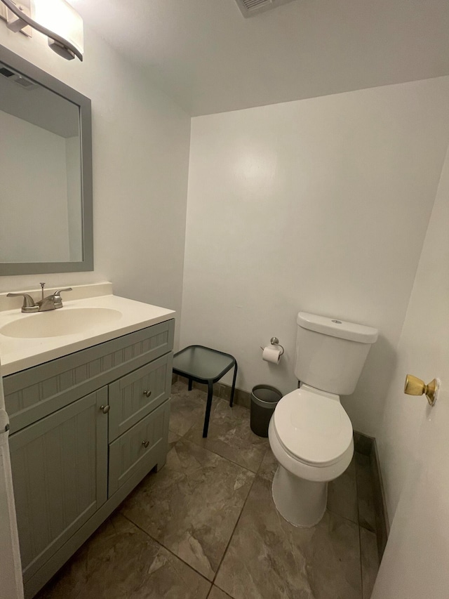 bathroom featuring vanity and toilet