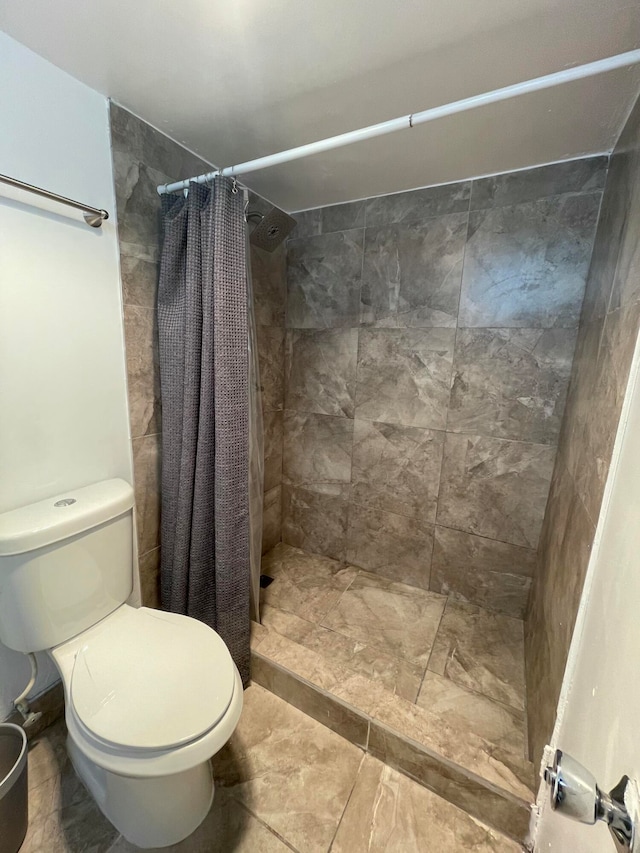 bathroom featuring toilet and a shower with shower curtain