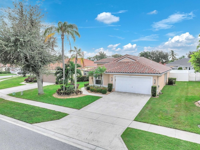 mediterranean / spanish home featuring a front lawn and a garage