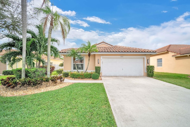 mediterranean / spanish home featuring a garage and a front yard