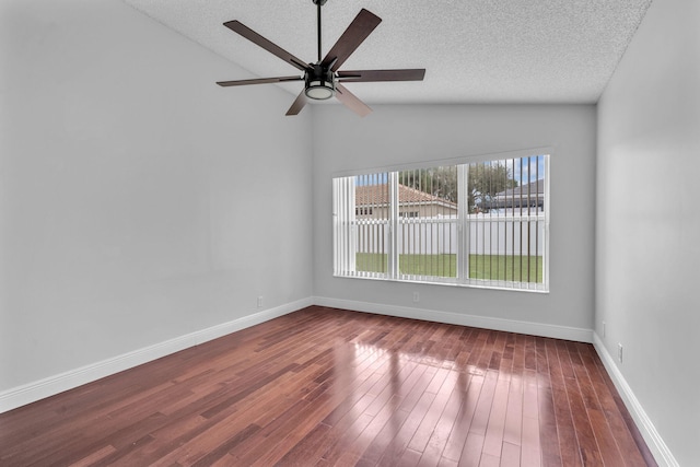 unfurnished room featuring ceiling fan, wood-type flooring, a textured ceiling, and vaulted ceiling