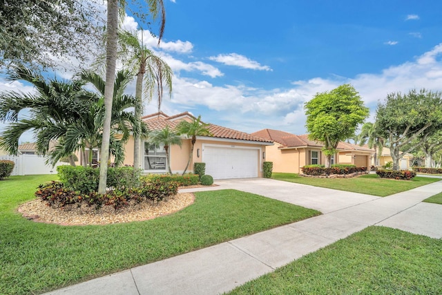 mediterranean / spanish-style home with a front lawn and a garage