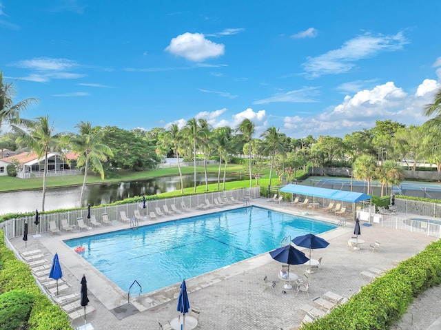 view of swimming pool featuring a patio area and a water view