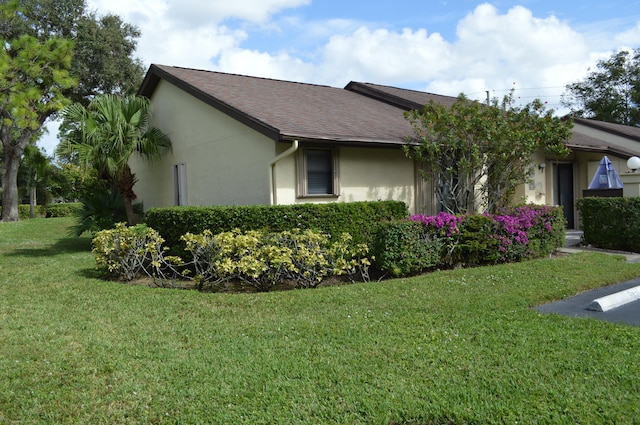 view of home's exterior with a lawn